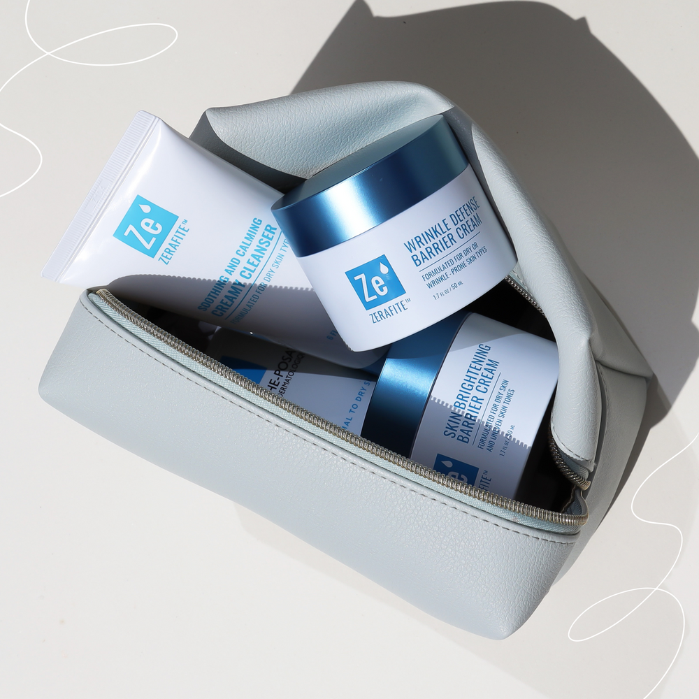 Zerafite skincare products including a jar and tube in a light blue pouch on a neutral background