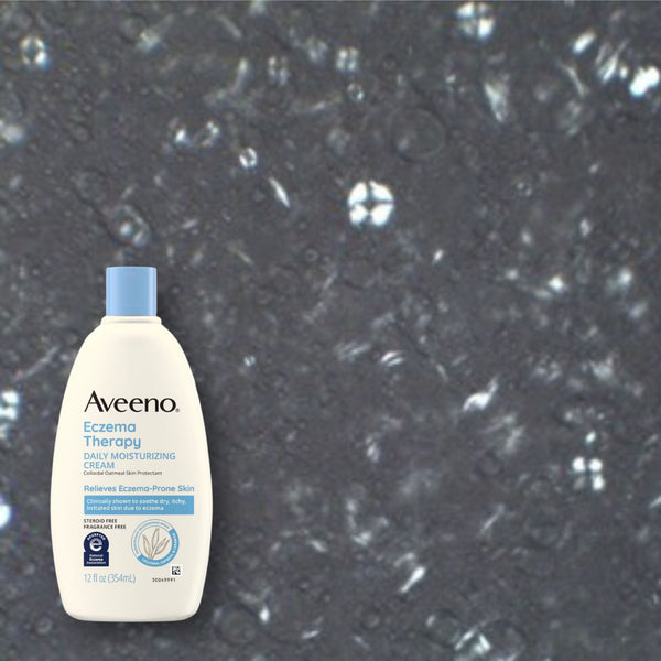 Cross-polarized microscopy of Aveeno Eczema Therapy Daily Moisturizing Cream showing irregular crystalline streaks and shards.