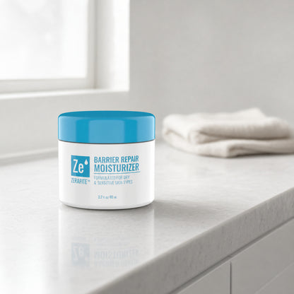 A jar of Zerafite Barrier Repair Moisturizer on a pale stone bathroom counter next to a folded white towel.