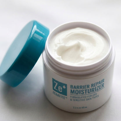 Open jar of Zerafite Barrier Repair Moisturizer, lid off, showing thick white cream inside.