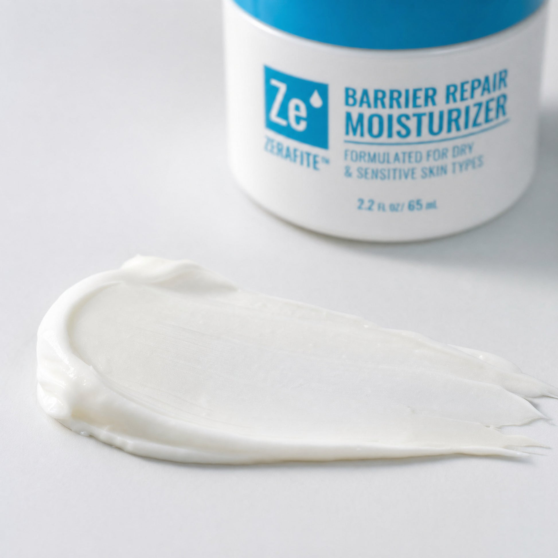 A thick white swatch of Zerafite Barrier Repair Moisturizer smoothed across a white surface.