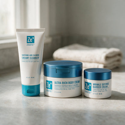 The Zerafite Essentials Bundle on a stone bathroom counter beside folded towels, lit by a window.