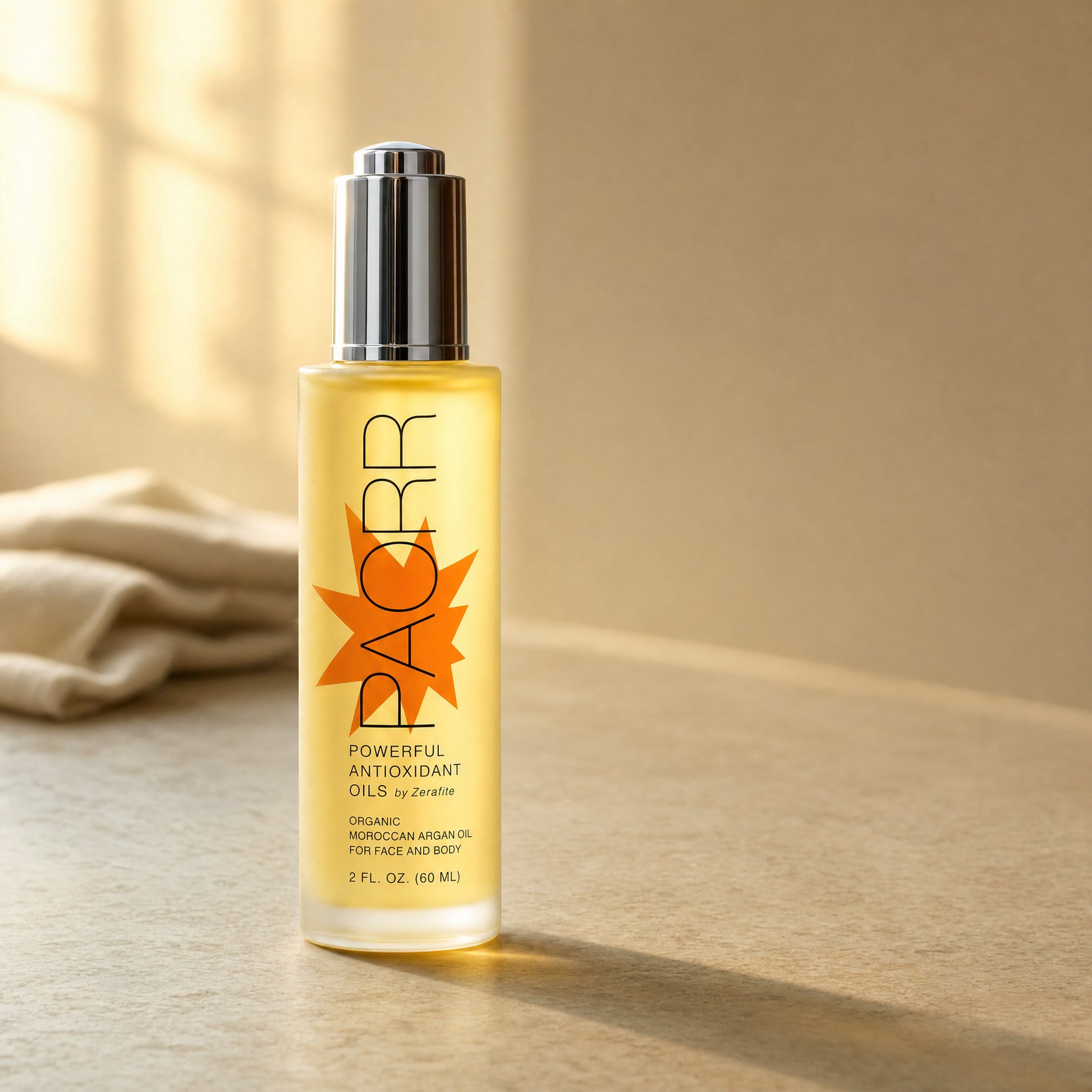 A bottle of Paorr organic Moroccan argan oil by Zerafite on a counter in warm window light beside a folded linen towel.