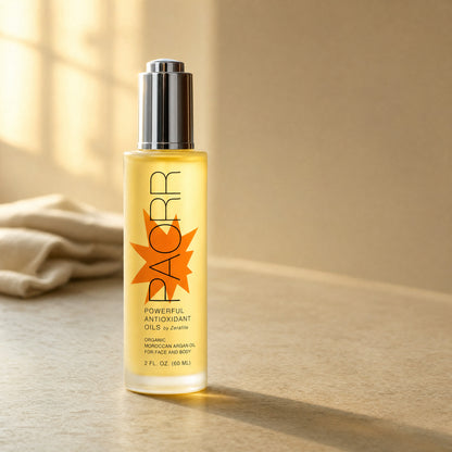 A bottle of Paorr organic Moroccan argan oil by Zerafite on a counter in warm window light beside a folded linen towel.