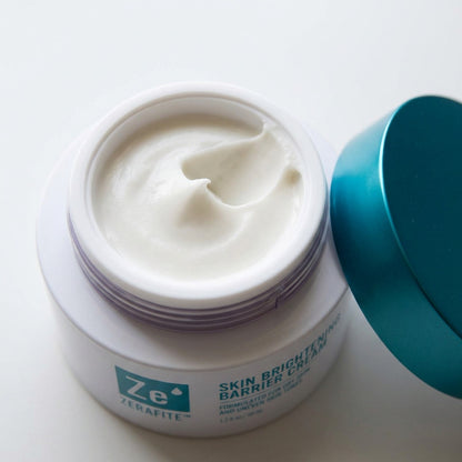 The white Zerafite Skin Brightening Barrier Cream that fills each refill pod, shown in the open jar.