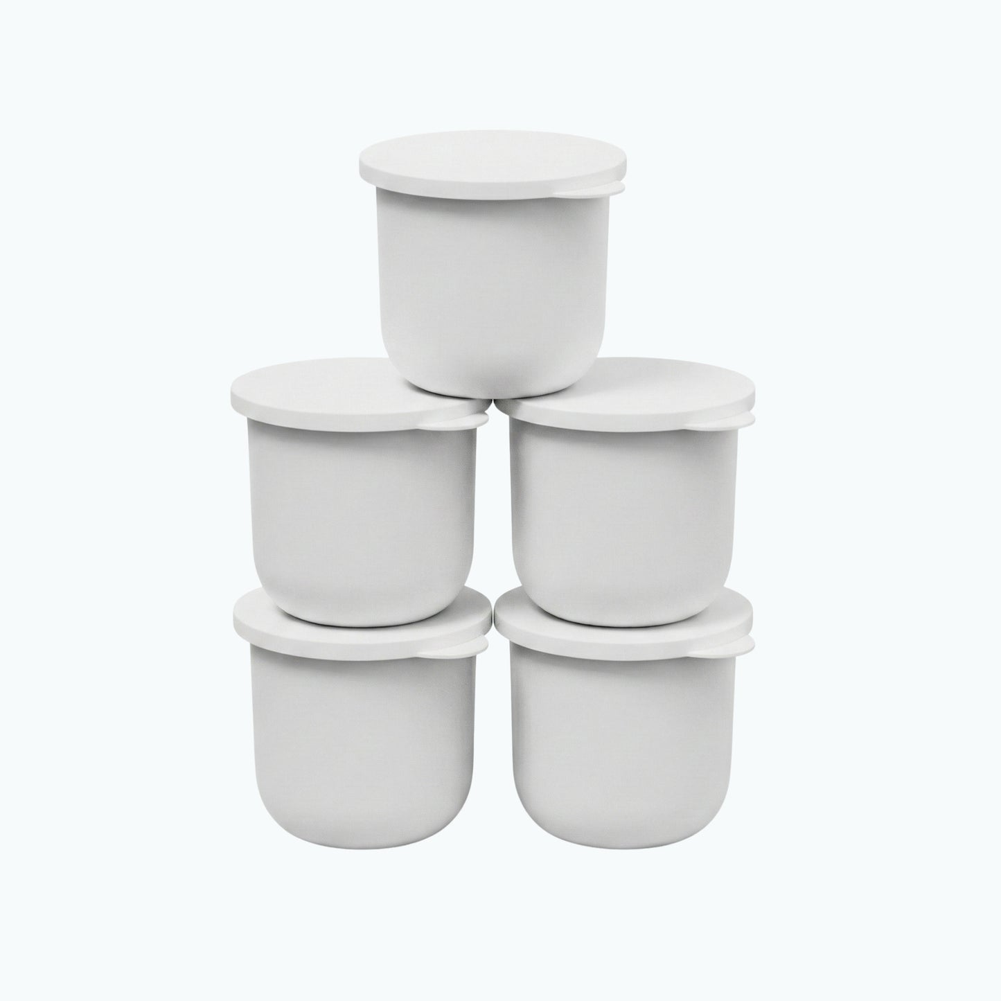 Five white Zerafite Skin Brightening Barrier Cream refill pods stacked in a pyramid.