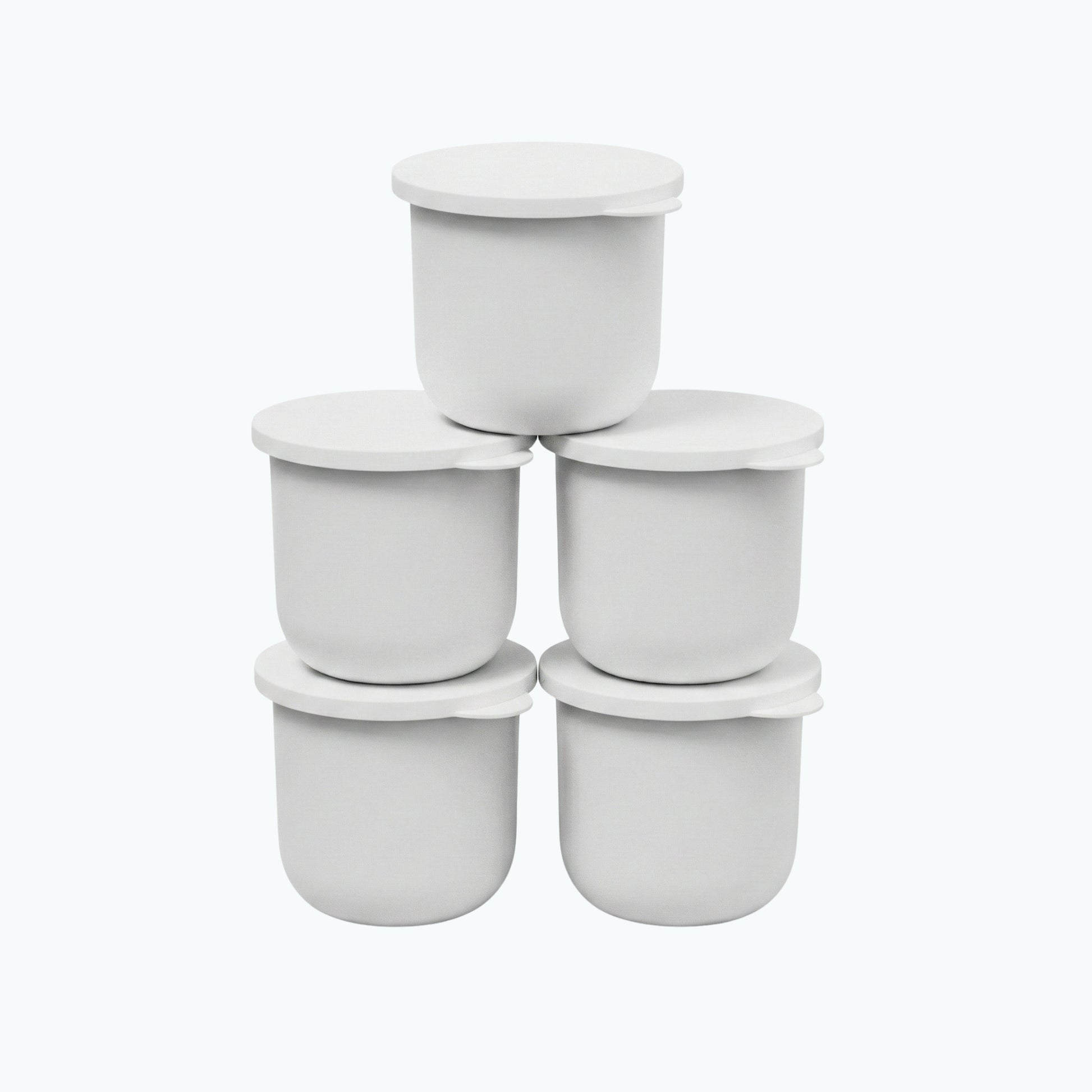 Five white Zerafite Skin Brightening Barrier Cream refill pods stacked in a pyramid.