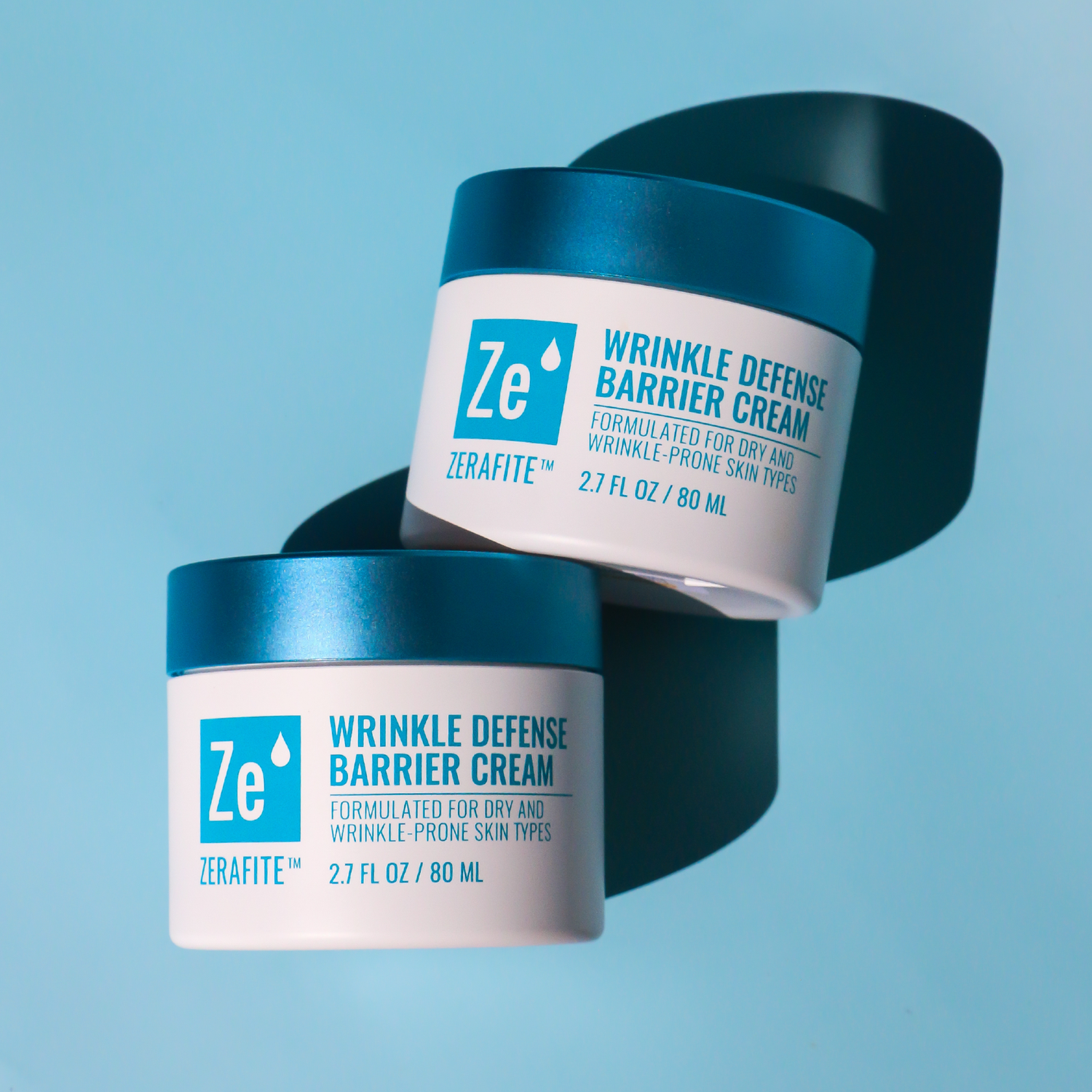 Two jars of Zerafite Wrinkle Defense Barrier Cream on a blue background